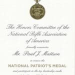 A medal is shown with the words " national patriot 's medal ".