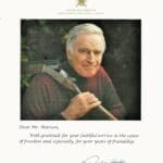 A picture of an older man holding a hammer.