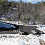 A large piece of metal sitting in the snow.