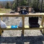 A bench with bags and suitcases on it