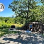 A laptop and computer sitting on top of a table.
