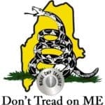 A picture of the state of maine with a silver coin.