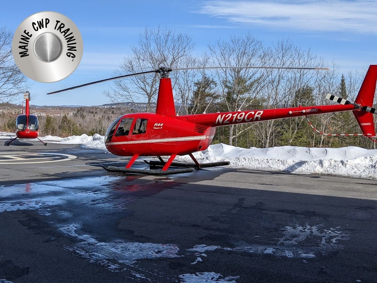 MDW LANDING ZONE A red helicopter sitting on top of an airport runway.